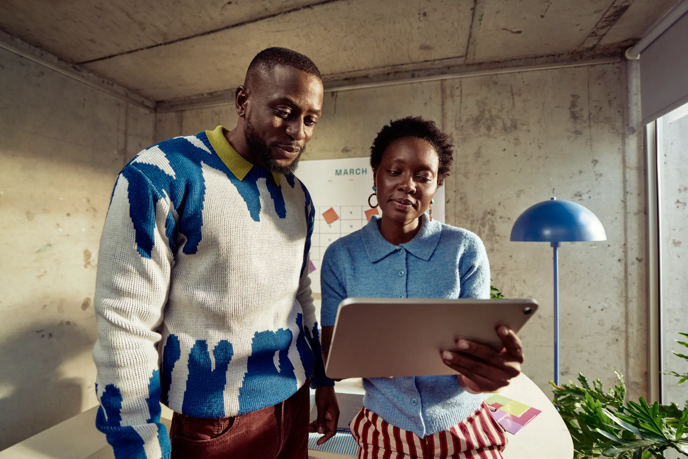 Two business owners reviewing a design on a tablet
